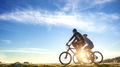 Two cyclists, cycling
