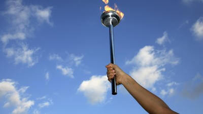 Hand holding olympic torch