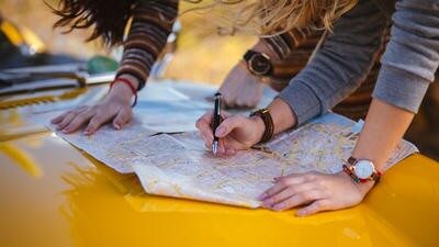 Women on trip reading map