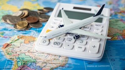 Calculator and toy plane on a map