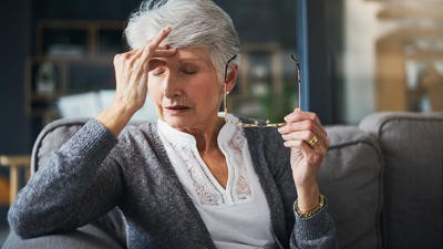 Elderly woman looking stressed