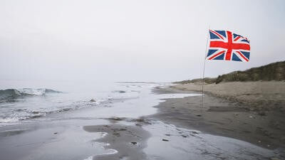A lone Union Jack on the cold grey beach of Brexit
