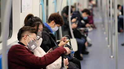 Chinese citizens wear protective masks on the subway