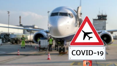 Airplane at the airport warning sign coronavirus