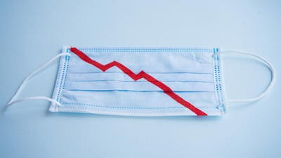 Face mask with a line representing economic downturn caused by coronavirus