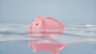 A piggy bank sinking below the water