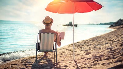 Man on beach in deckchair