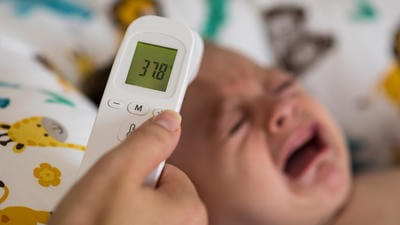 Baby getting temperature read