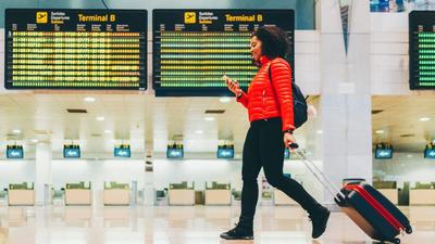 passenger with luggage at airport