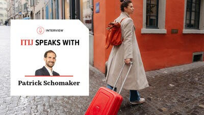 Woman walking cobbled streets with suitcase