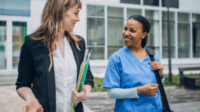 Two hospital workers talking to each other