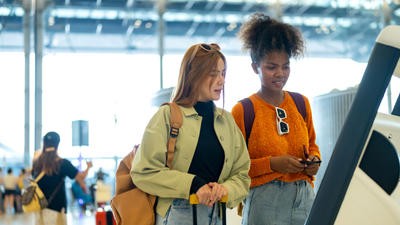 Two young adults at the airport check-in
