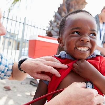 A doctor helping a patient overseas