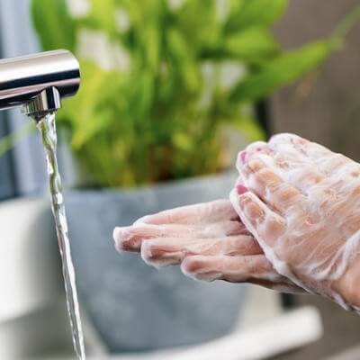 Someone thoroughly washing their hands