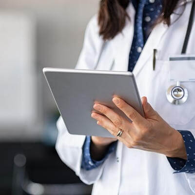 Woman doctor checking tablet