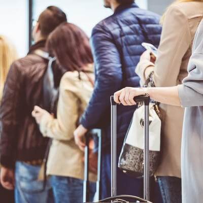 Passengers queue at airport