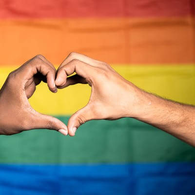 Love symbol in front of pride flag