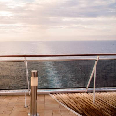 Woman on cruise ship at sunset