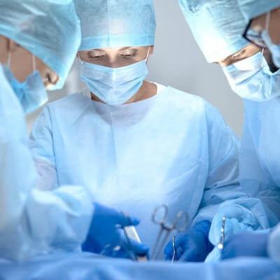 Four medics performing surgery