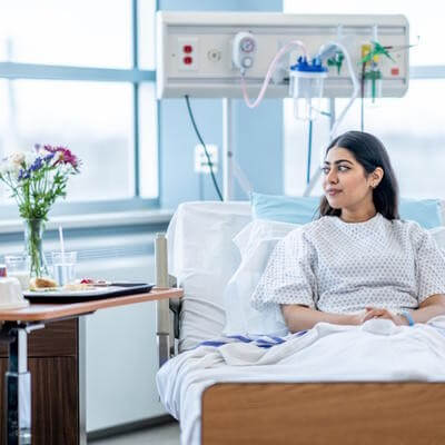 hospital woman in bed with flowers