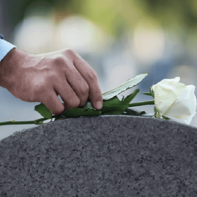 flower on headstone at funeral