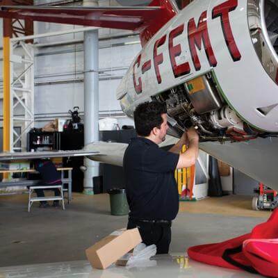 engineer working on air ambulance aircraft engine