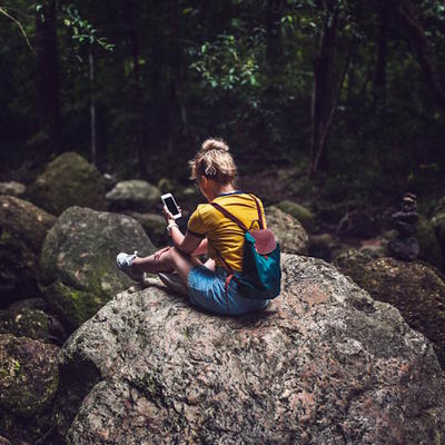 Girl in jungle using phone