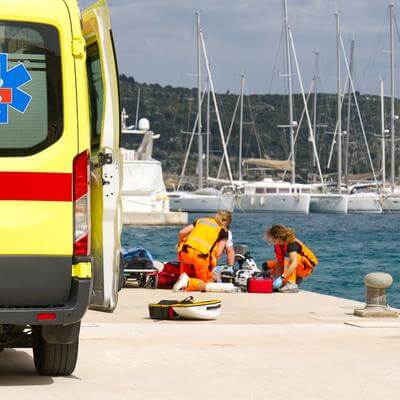 ambulance and medical crew providing assistance at harbourside
