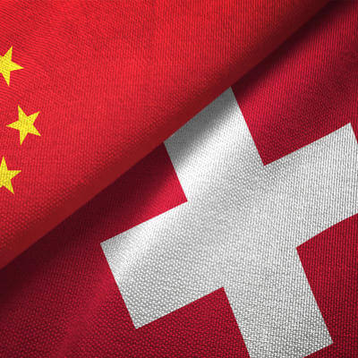 Image of adjacent Chinese and Swiss flags