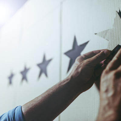 Image of hands placing cut out stars on a board