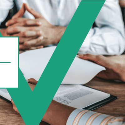 Picture of people looking through forms in a meeting