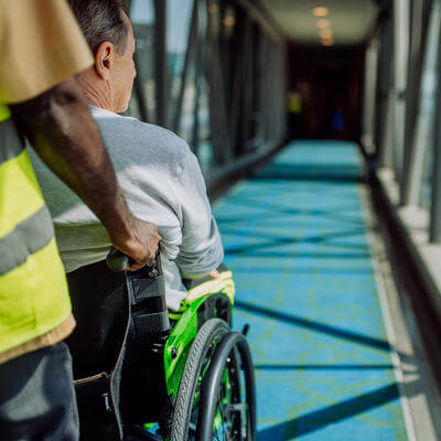 Image of travel assistant and traveller boarding plane 