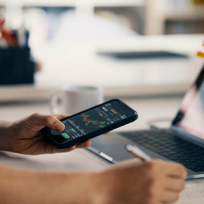 Image of man with phone organising finances