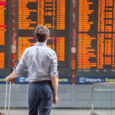 Man looking at airplane flight board