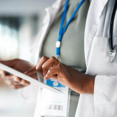 Image of medical worker using tablet while working
