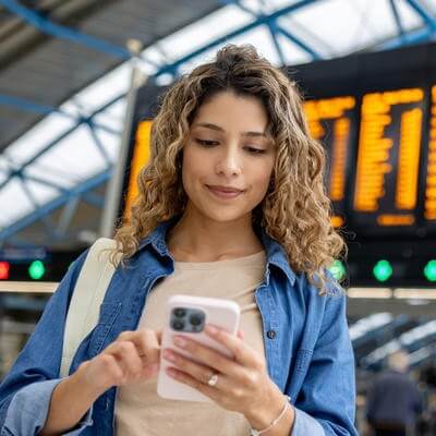 Image of woman at airport checking phone