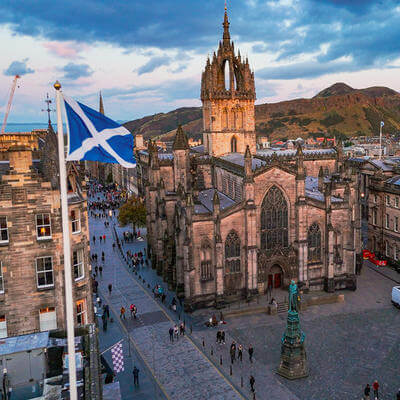 Aerial view of St. Giles Cathedral and Edinburgh old town with Scottish flag