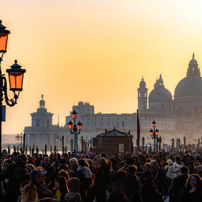 Image of crowds at the carnival in St. Mark's Square, in the background the Basilica of Santa Maria della Salute,Venice, Italy