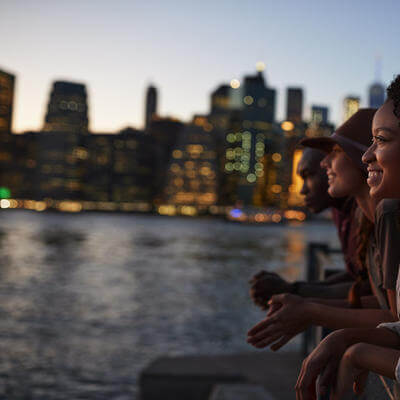 Group of young friends on trip to Manhattan at dusk