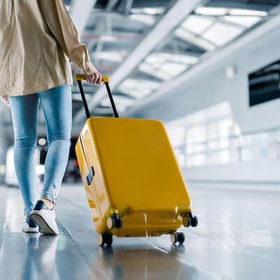 Young traveller with suitcase at airport