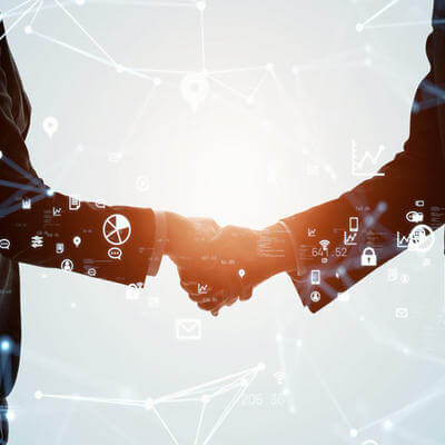 Image of two business workers shaking hands signifying dealership