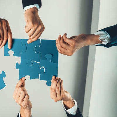 Top view panorama banner of business team assembling jigsaw puzzle
