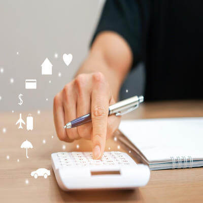 Close up of hand pressing on calculator to calculate spending