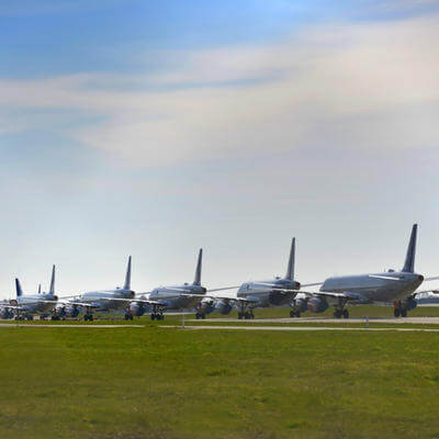 Multiple grounded airplanes parked on the runway