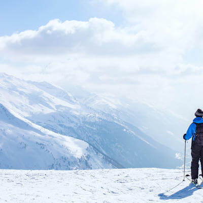 Skiing background, skier in beautiful mountain landscape