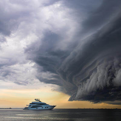 Luxury yacht under a scary looking tropical "shelf cloud"
