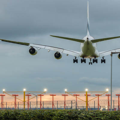 Plane landing on the airport at the sunset time