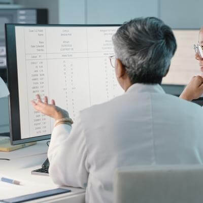 Science, hospital and women on computer for research, medical report and data analytics in laboratory