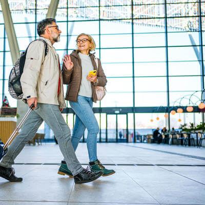Mature couple of passengers at the train station
