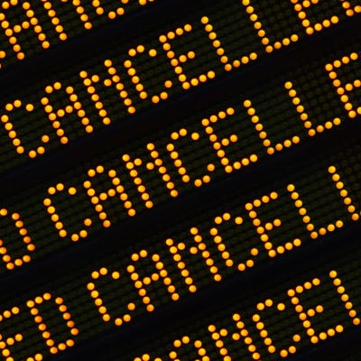 A Close Up Of The Word Cancelled Repeated Multiple Times On A Sign At A Station Or Airport